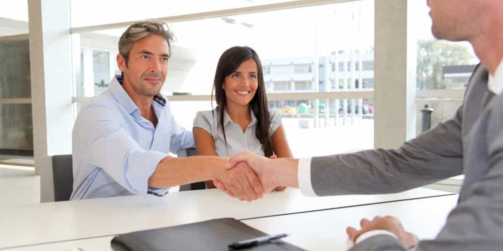 Man giving handshake to real-estate-agent